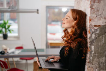 Attractive redhead woman standing daydreaming